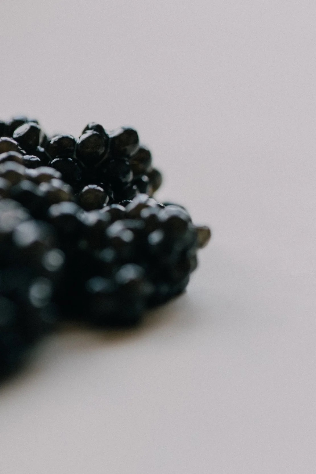 Baerii caviar pearl detail — firm texture, toasted nut and briny notes